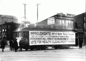 The photograph below shows a trolley with an advertisement for improvement in the year 1903.